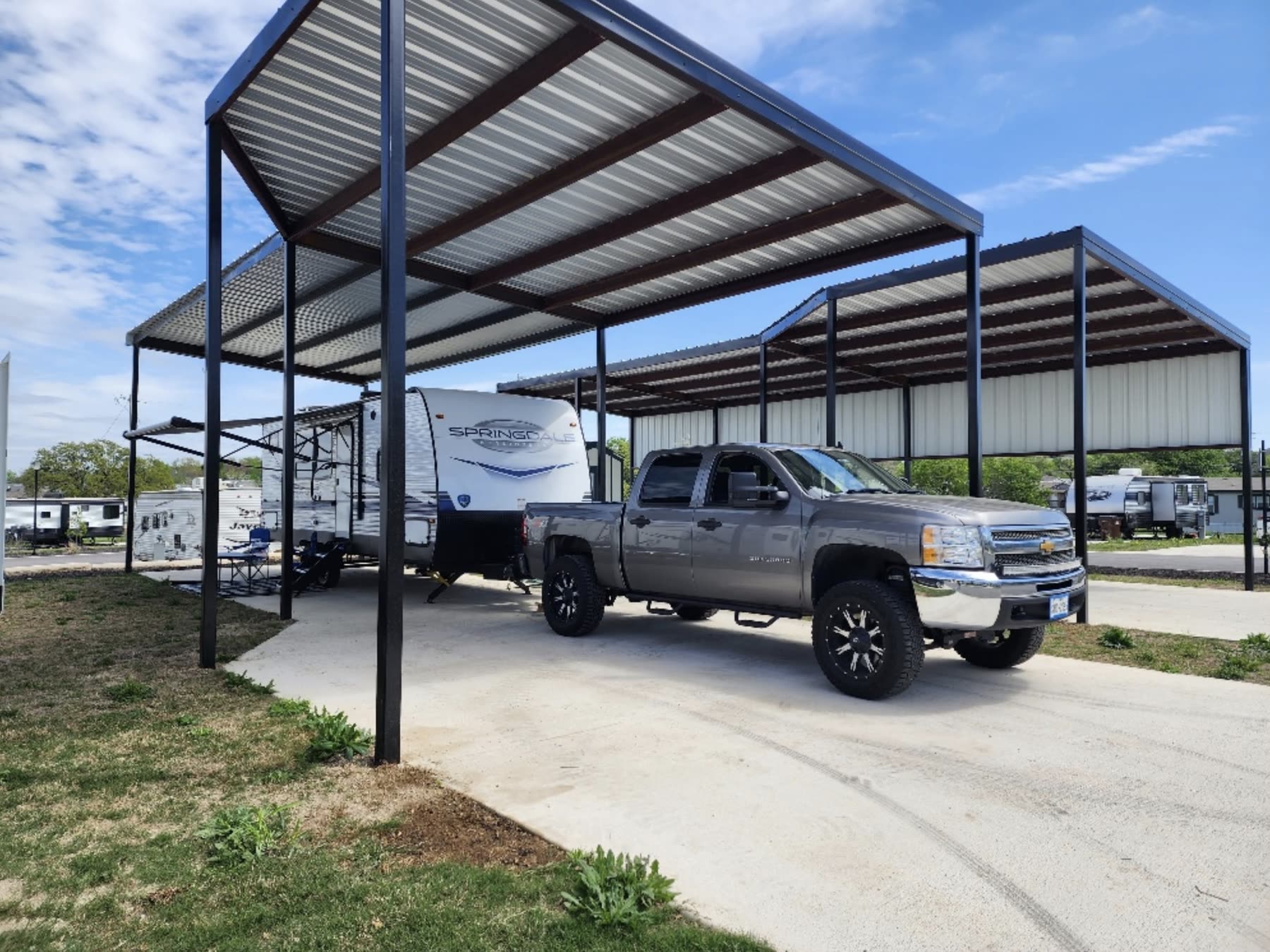 Covered RV site with overhead solar shade