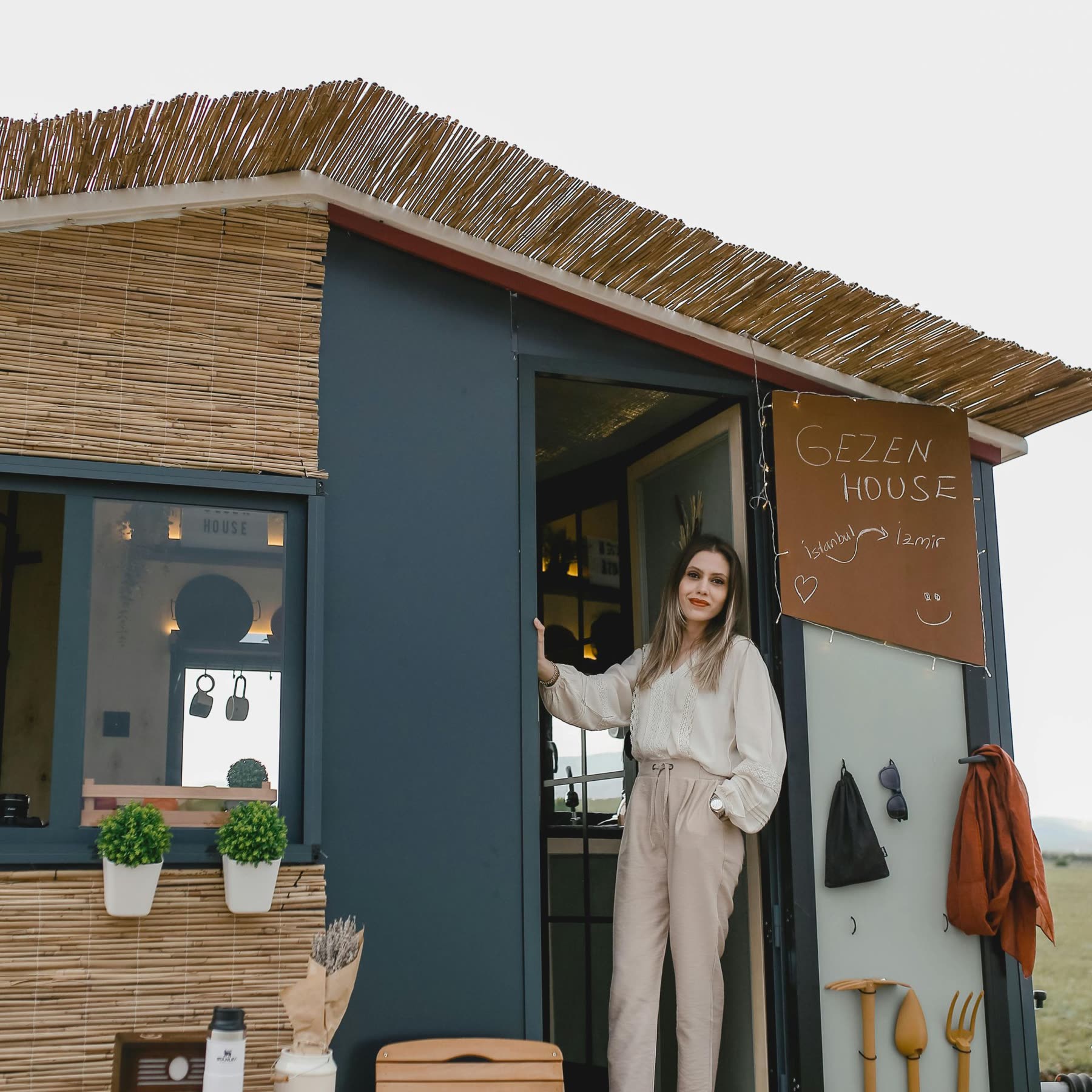 Resident standing outside her tiny home